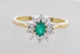 An 18ct gold diamond and emerald diamond ring havi