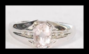 A hallmarked 9ct gold ring set with a very pale pi