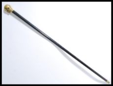 An early 20th century walking stick cane having a bronze skull knop handle set to a tapering