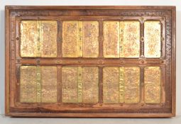 A large Moorish sheesham wood and brass coffee table. The 6ft wide table with stunning recessed