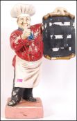 A 20th Century retro shop advertising point of sale fibreglass baker / chef holding a black