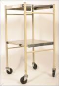 Sidhill Care Ltd - A 20th Century retro medical hospital square two tier trolley having a tubular