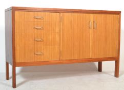 A 1960's mid Century teak wood sideboard having a twin door shelved cupboard alongside a run of four
