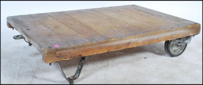 A vintage industrial 20th century trolley having pressed metal and rubber wheels with formed steel