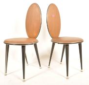 A pair of 1960's vinyl Italian dining chairs in the manner if Gio Ponti. Raised on ebonised tapering
