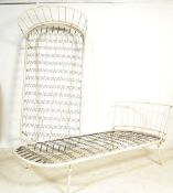 A pair of retro mid century single beds in the manner of Ernest Race being constructed of tubular