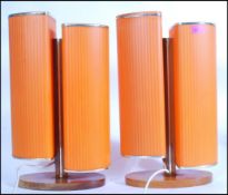 A pair of retro 20th Century circa 1960's table / bedside table lamps, the lamps raised on