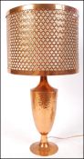 A 20th century contemporary industrial modernist table lamp having a beaten textured urn with lamp