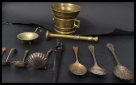 A  bronze twin handled pestle and mortar along wit