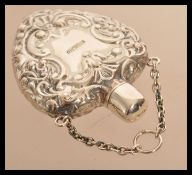 A sterling silver perfume bottle in the form of a