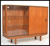 A vintage mid century teak wood display cabinet on