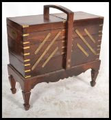 A 20th Century hardwood, brass inlaid concertina w
