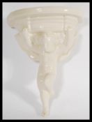 A Poole pottery white glazed wall bracket / clock