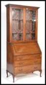 An early 20th century mahogany bureau library book