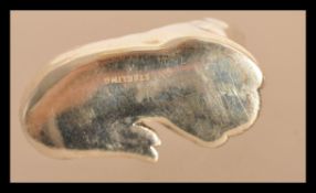 A sterling silver figurine of a cat playing with a