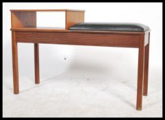 A retro mid century teak wood telephone table in t