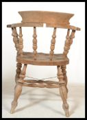 A Victorian beech and elm smokers bow armchair bei