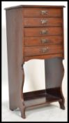 An Edwardian mahogany upright pedestal office filing cabinet having open shelf with fall front