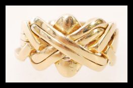 A high carat 22ct unmarked but gold testing Saudi Arabian puzzle ring of crossover form. Weighs 9.