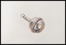 A hallmarked silver baby rattle of decorative form being hallmarked for Chester by J & R Griffin (