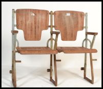 A pair of vintage Industrial mid  20th century cinema - theatre chairs. Set on a metal tubular frame