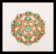 A vintage hallmarked 9ct yellow gold cluster ring set with turquoise in a filigree domed setting.