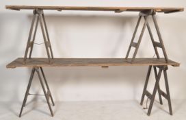 A pair of vintage retro 20th century trestle table tops raised on two sets of folding trestle  table