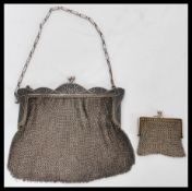 A silver ( tested ) vintage ladies mesh clutch purse with silver rococo clasp and bars complete with