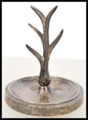 An early 20th century silver hallmarked ring stand raised on a beaded circular base with