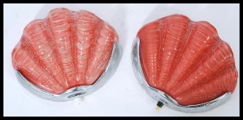 A pair of 1930's Art Deco clam shell wall lights. Clear glass with red painted backs set to chrome