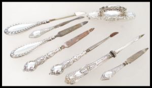 A collection of early 20th century silver hallmarked vanity picks to include 3 pairs with button