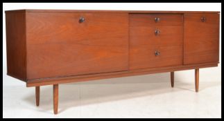 A vintage retro 20th century teak sideboard having a central bank of three drawers flanked by
