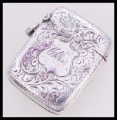 A silver hallmarked rococo chase decorated vesta with cartouche panel marked ' Chris ' Hallmarked