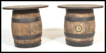 A pair of vintage early 20th Century oak coopered barrels of usual construction having a later