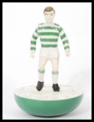 A Royal Doulton Subbuteo ceramic football figurine MCL 12 featuring a player in green and white