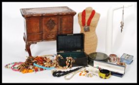 A large vintage wooden jewellery casket containing a collection of various costume jewellery and