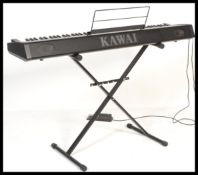 A good Kawai ES1 digital piano in working order, complete with stand, peddle, music books.
