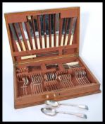 A vintage 20th Century oak cased silver plated canteen of cutlery, six person cover near complete (