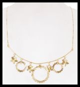 An 18ct gold Cleopatra necklace chain having a box link chain with faceted circular and leaf
