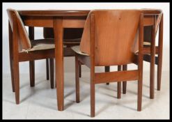 A vintage retro 20th century Elliotts of Newbury extending dining table and chairs.The table of
