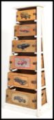 A vintage retro style metal storage rack having six wooden boxes depicting iconic classic cars.