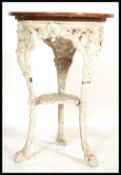 A 19th century Victorian cast iron pub tavern table having a scrolled base with face masks and