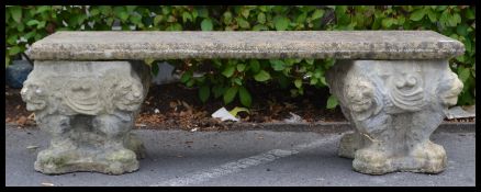 A vintage 20th century reconstituted stone bench comprising of two square planter type ends and