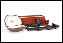 A group of three vintage 20th century smoking pipes to include a London Made example, one with a