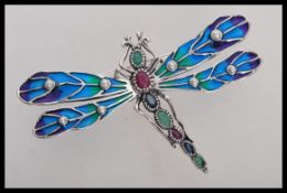 A large sterling silver and plique a jour brooch in the form of a dragonfly with pearl set wings and