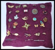 A collection of costume jewellery brooches to include yellow metal examples. enamel painted, stone