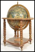 An antique style cocktail drinks cabinet in the form of a globe with hinged top section to fitted