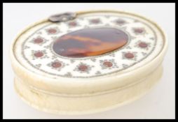 A 18th century Ivory and Tortoiseshell snuff box of oval form with central tortoiseshell cartouche