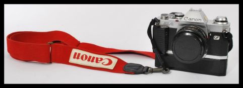 A vintage 1983 Canon AL-1 SLR Camera complete with authentic Canon neck strap, power winder and FD