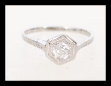 A 14 carat hexagon diamond ring featuring a built in setting and engraving on the shank. The item